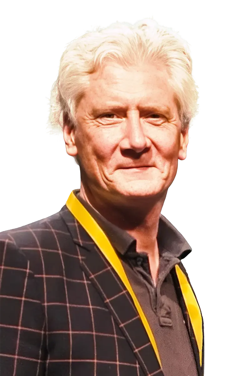 Daragh Connolly wearing a checkered blazer with a yellow tie against a white background